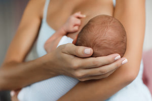 A Woman Holding a Breastfed Baby
